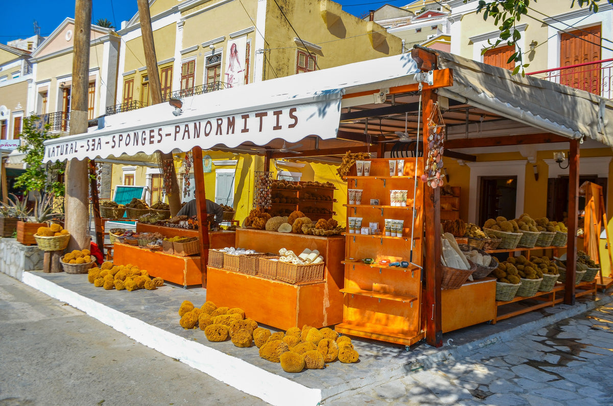The shopfront on Yialos harbour, baskets of sponges under the awning